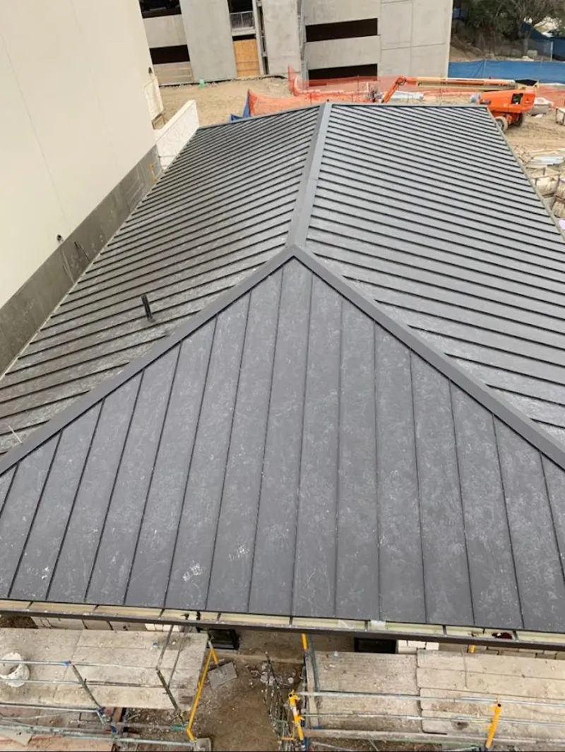 Commercial metal roof construction with crane equipment in Coto de Caza