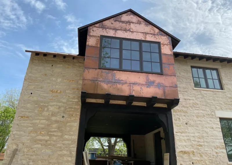 Copper metal panel facade on a stone building for Skylight Installation in Coto de Caza
